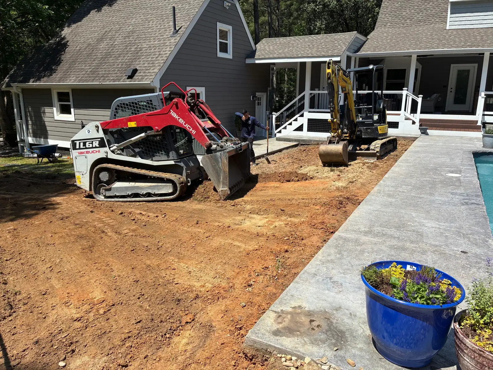 Leveling the cleared ground beside the pool