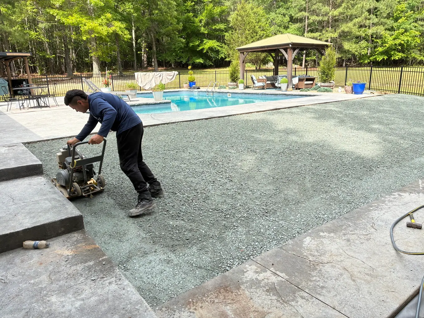 Compacting the base beside the concrete walkway