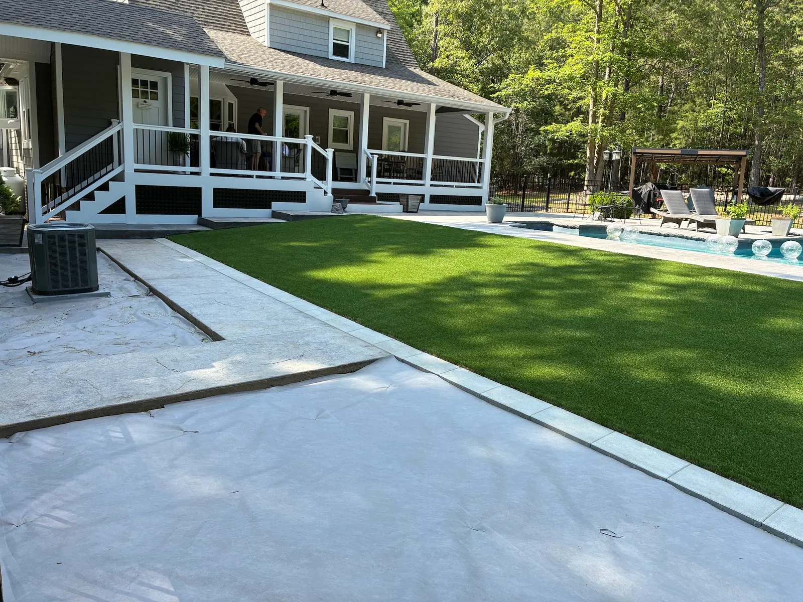 Artificial turf meeting the poolside patio and steps