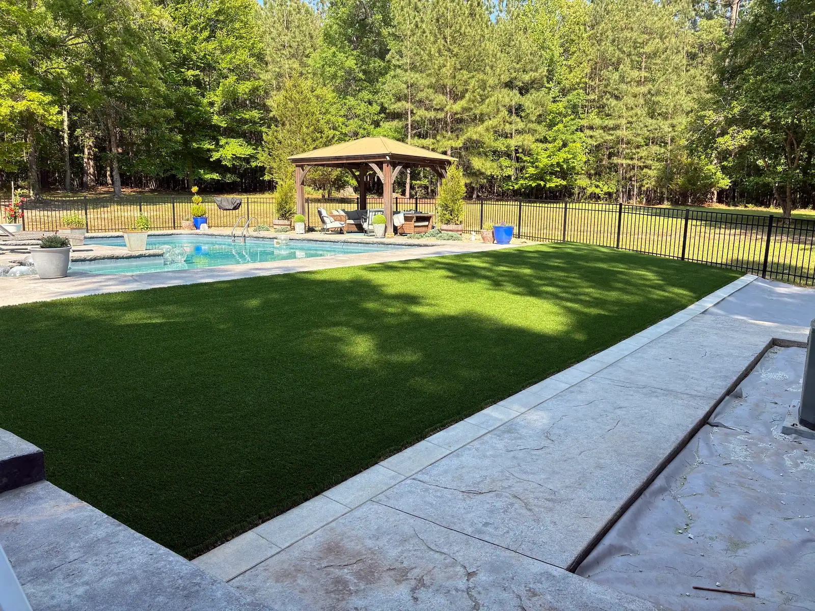 Finished poolside turf with surrounding garden views