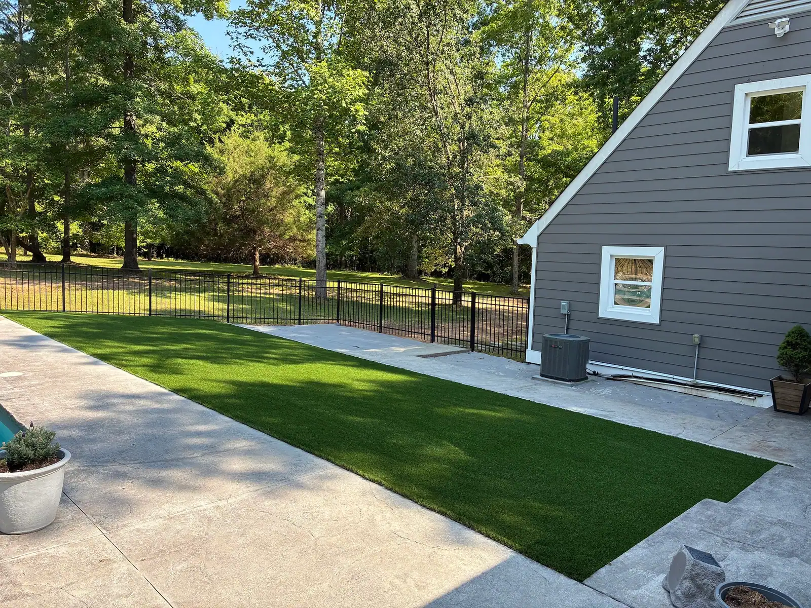Finished artificial turf beside the house and pool