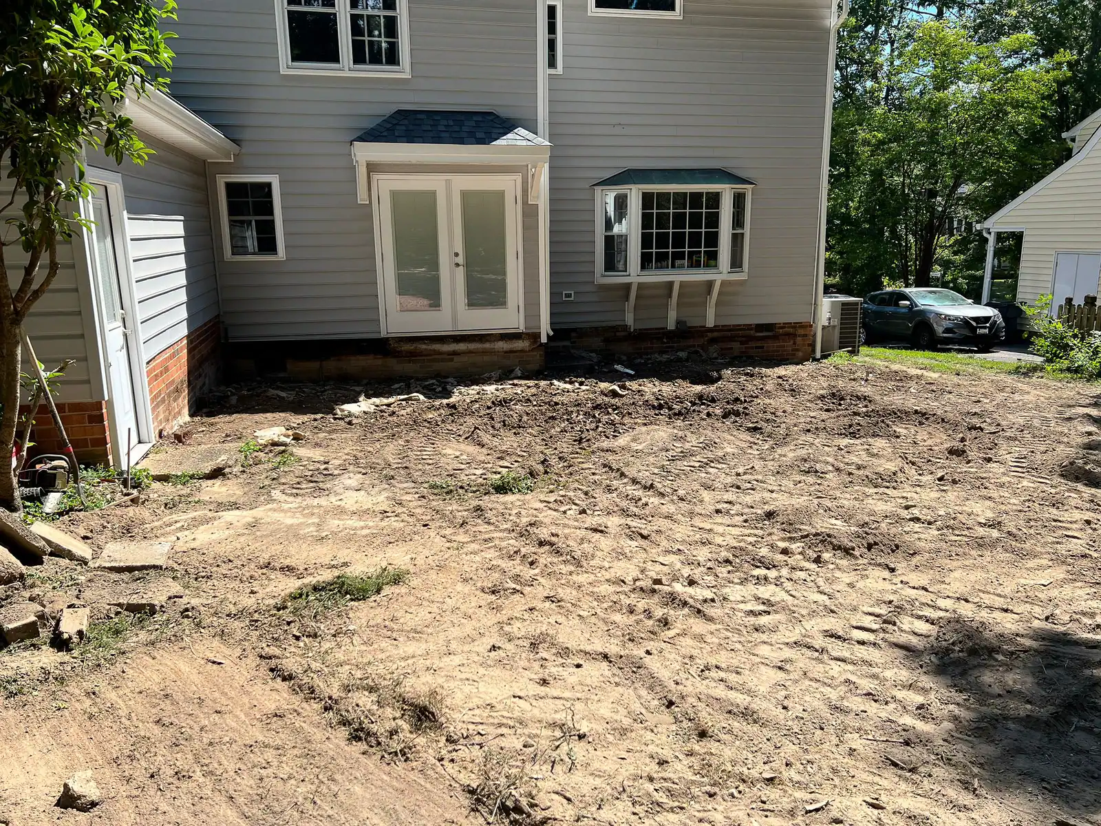 Cleared ground after removal of the original wooden deck