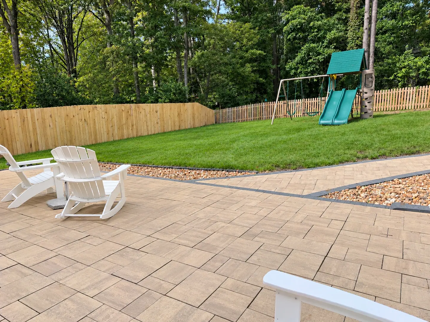Finished paver patio with outdoor seating and a backyard playset