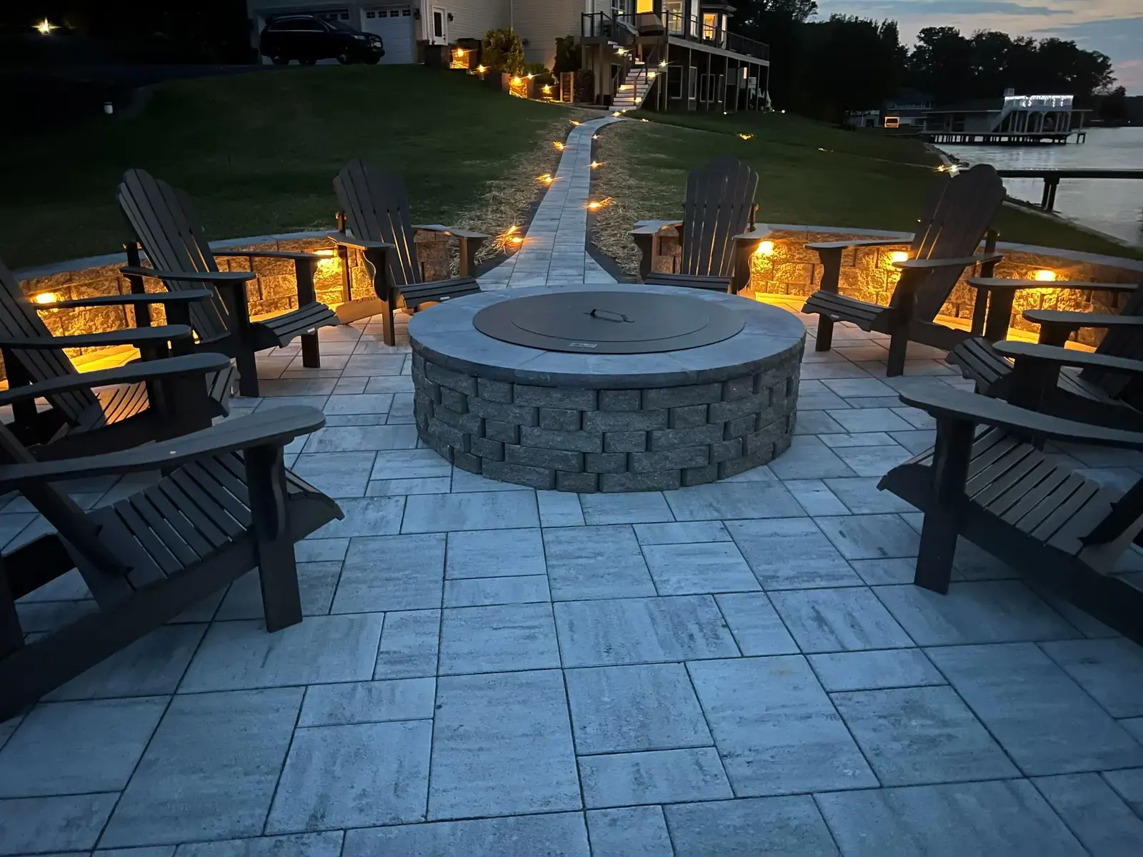 Lakeside seating area illuminated after dark