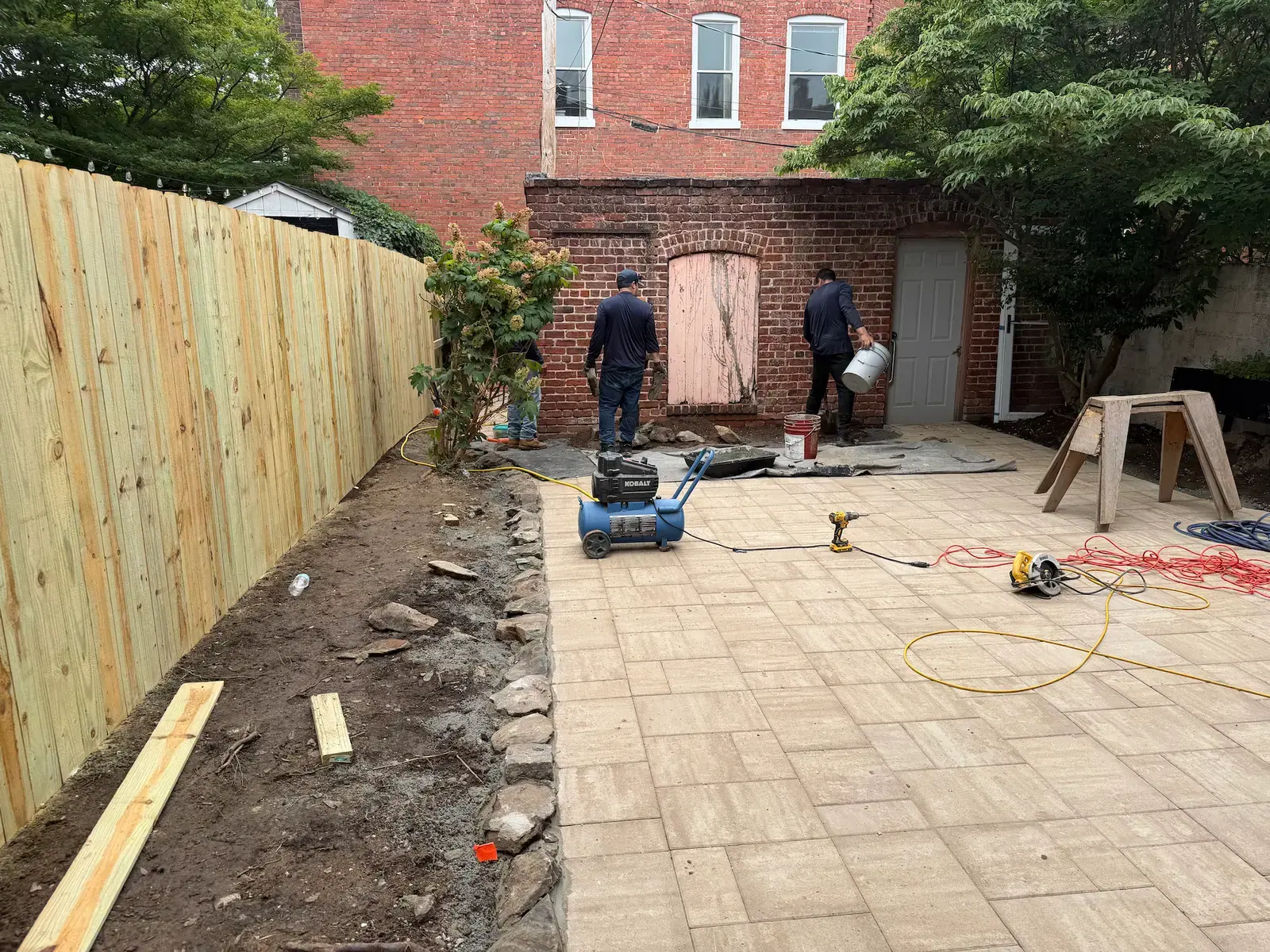 Patio finishing work near the brick garden building