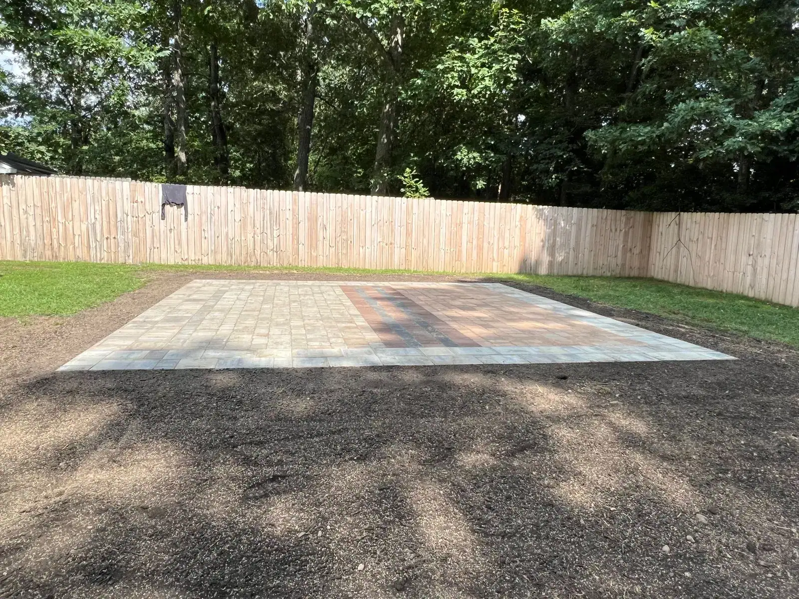 Finished paver surface beside the lawn