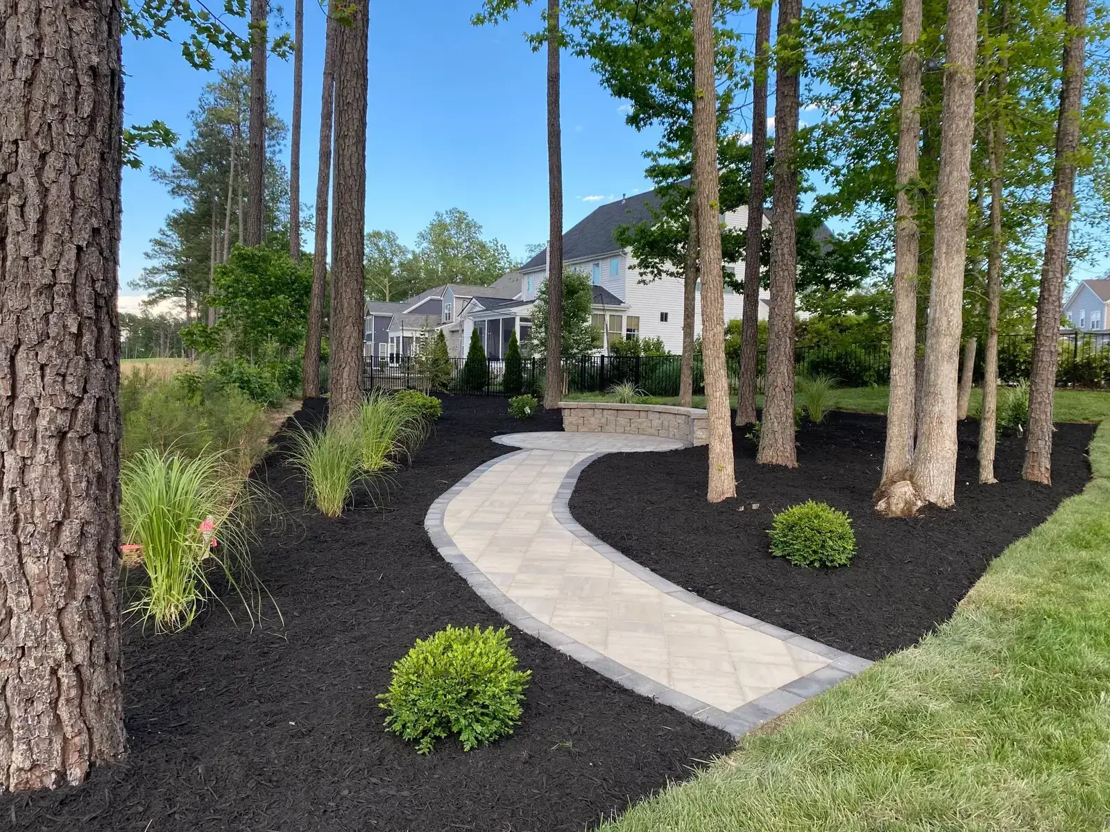 Curved walkway through mulched planting beds
