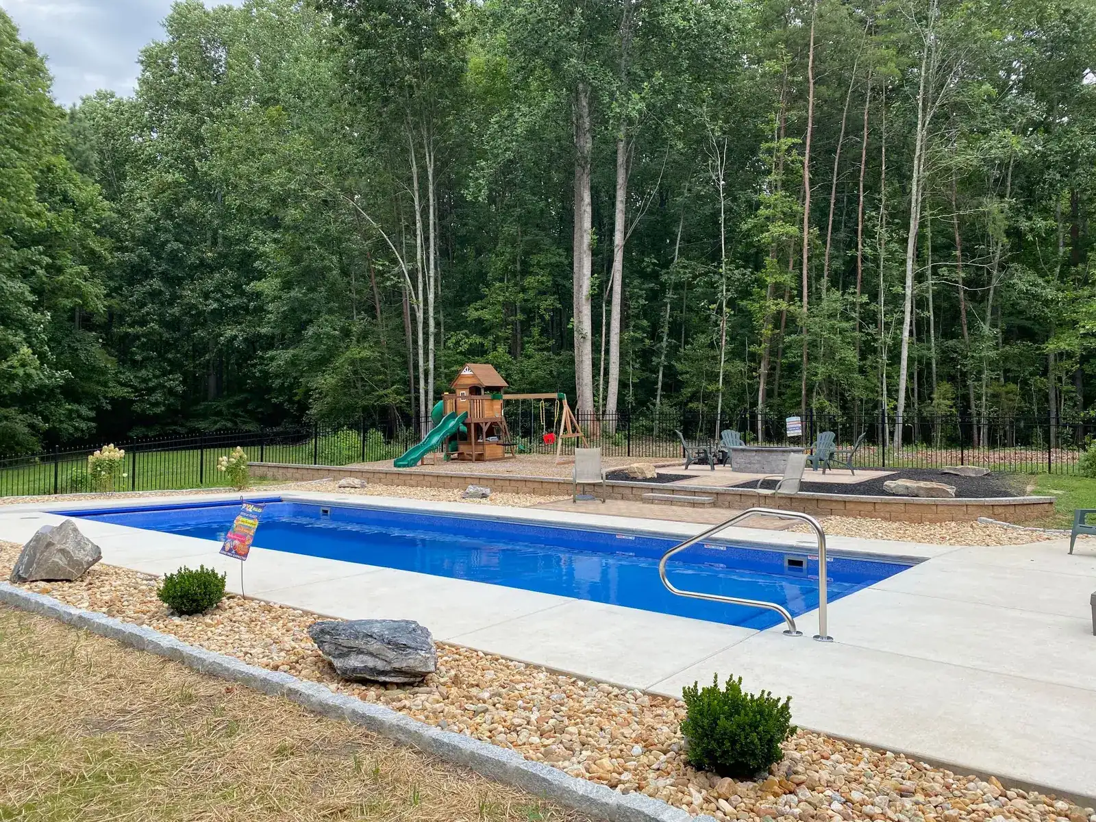 Pool Side: Pool surrounded by river rock and planting