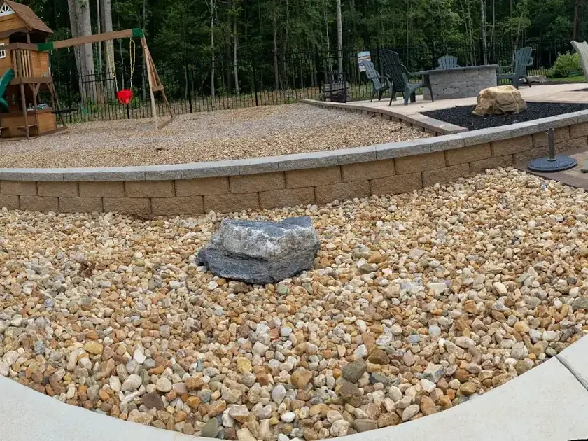 Curved retaining wall and stone ground cover