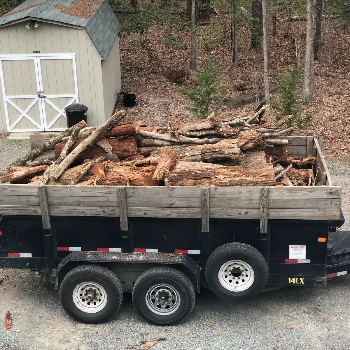 Truck hauling cleared timber and yard debris
