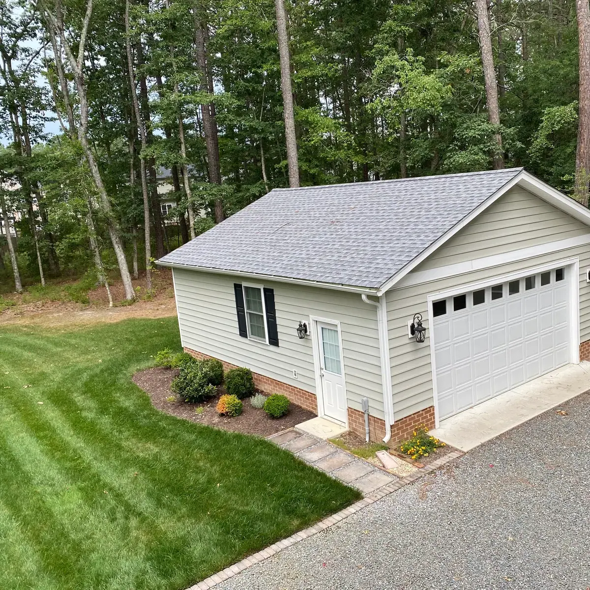 Completed garage and surrounding landscape. Lawn was grown from seed; building not constructed by Willow Landscaping.