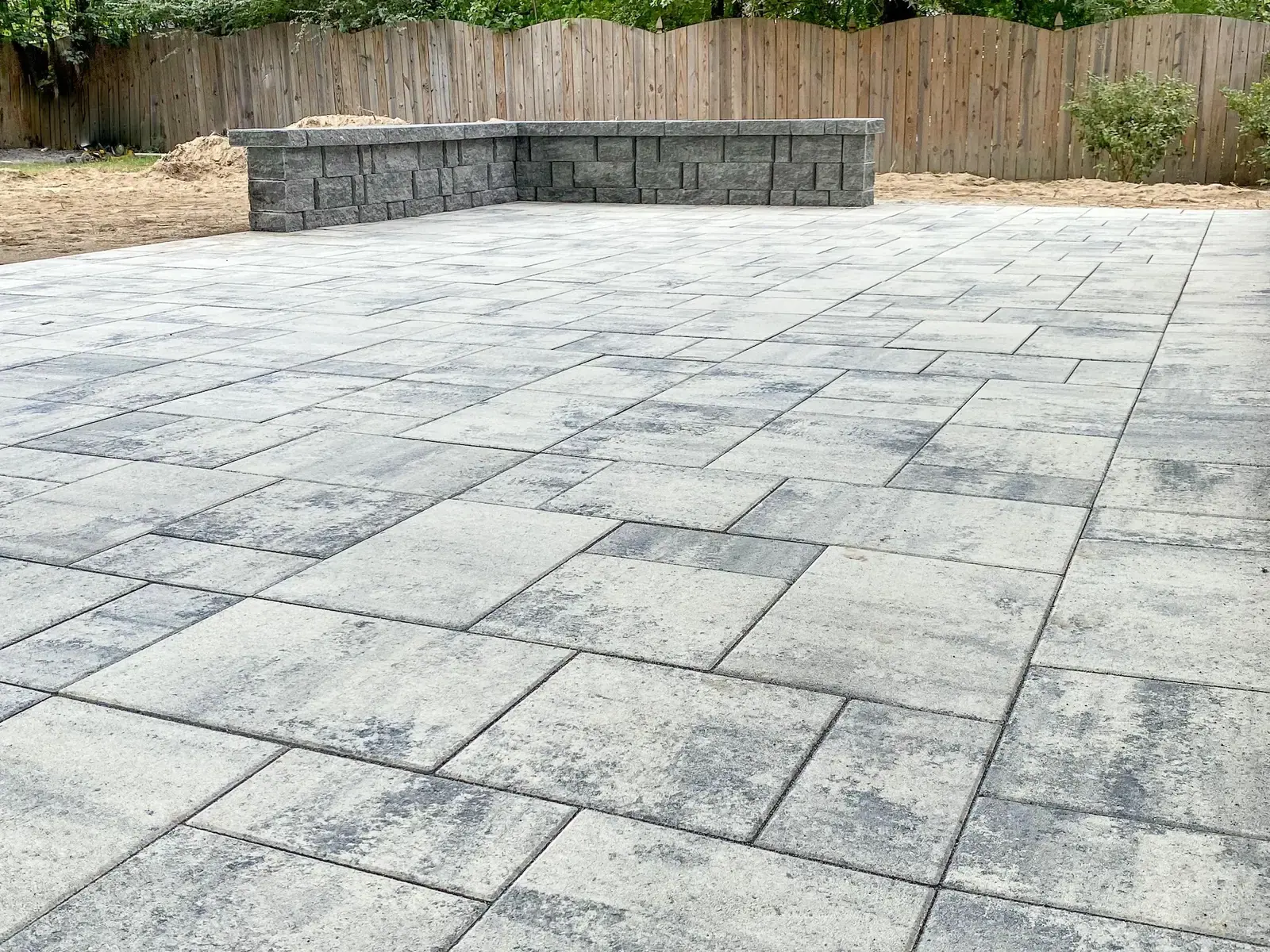 Finished patio surface and low walls along the boundary