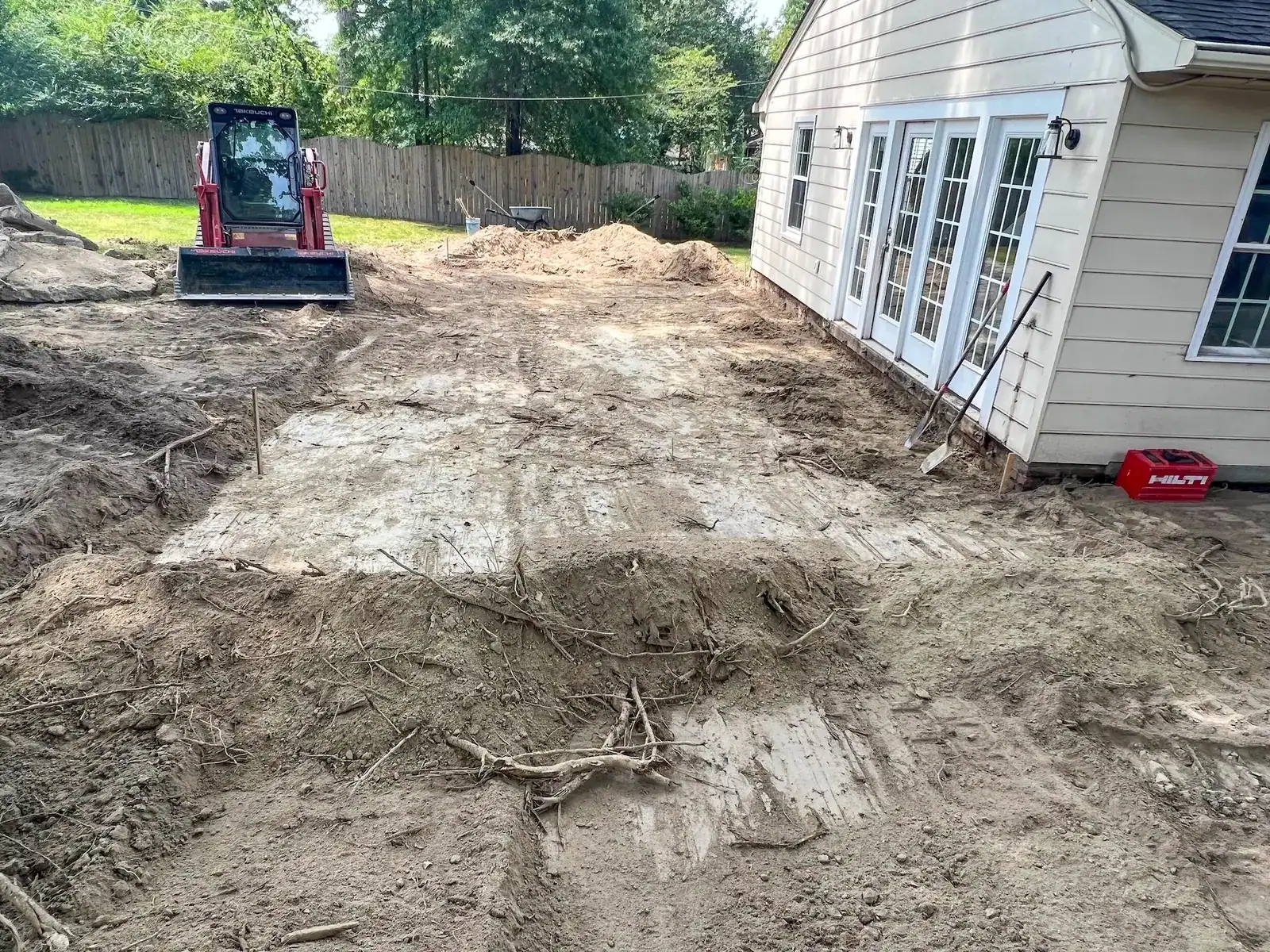 Excavation beside the home after deck removal