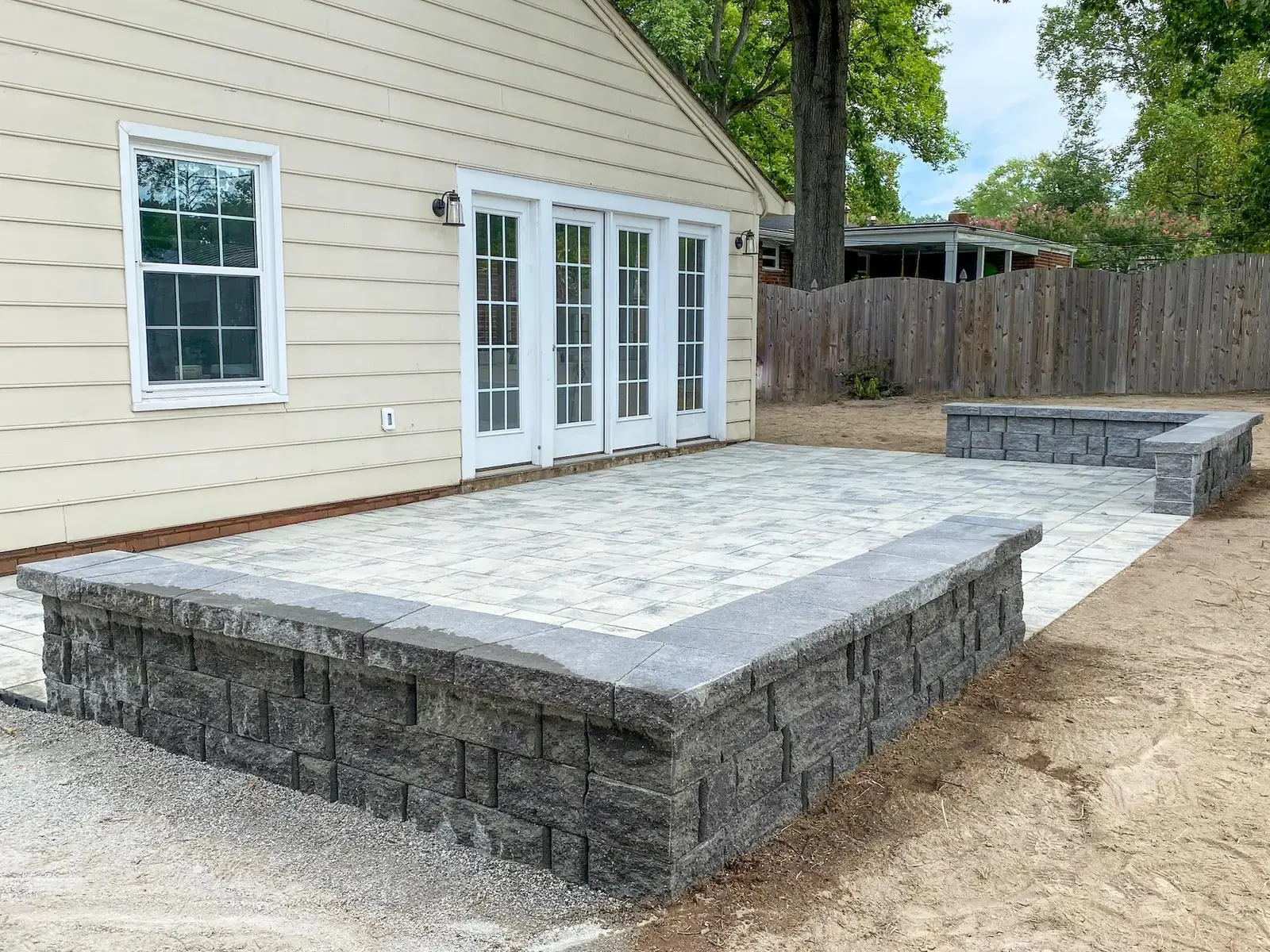 Replacing a Deck: Finished paver patio with capped block walls