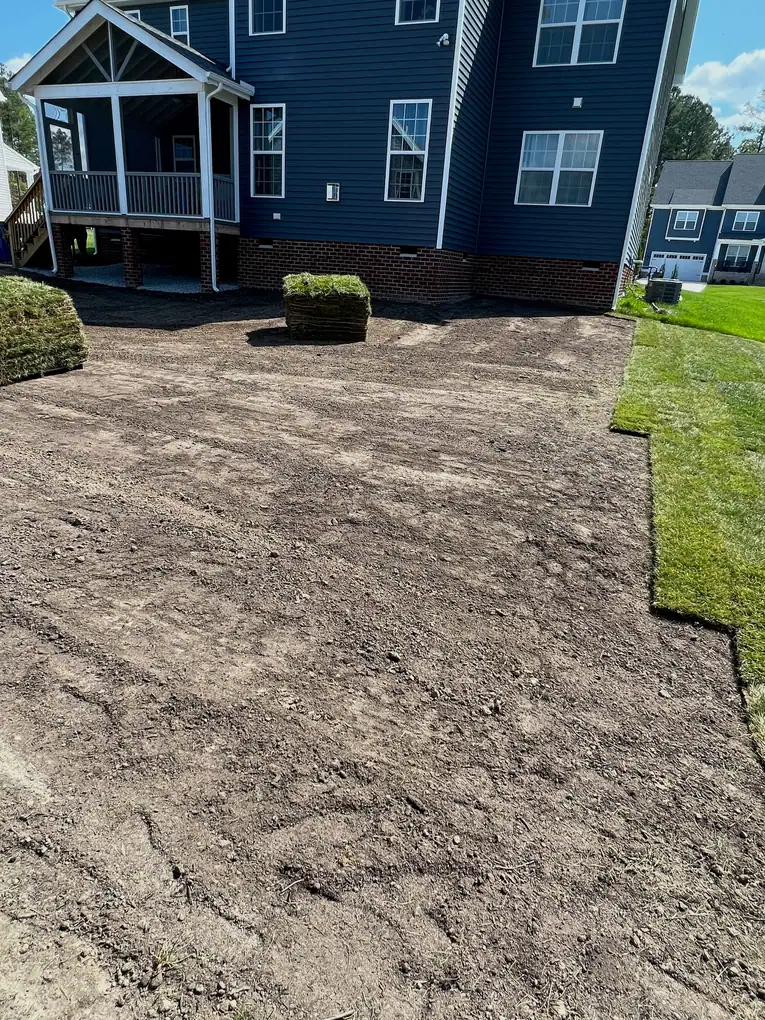 Prepared ground beside newly installed sod