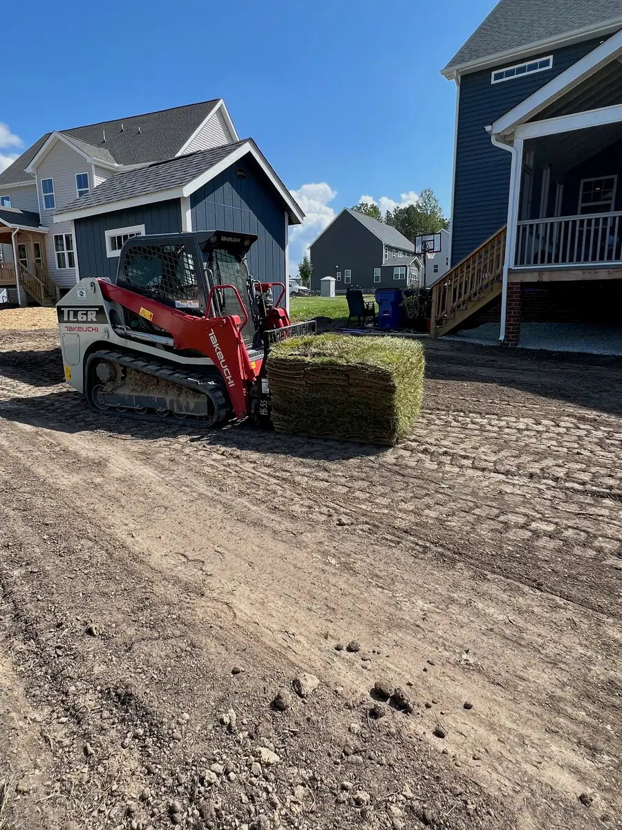 Tracked equipment preparing the remaining lawn area