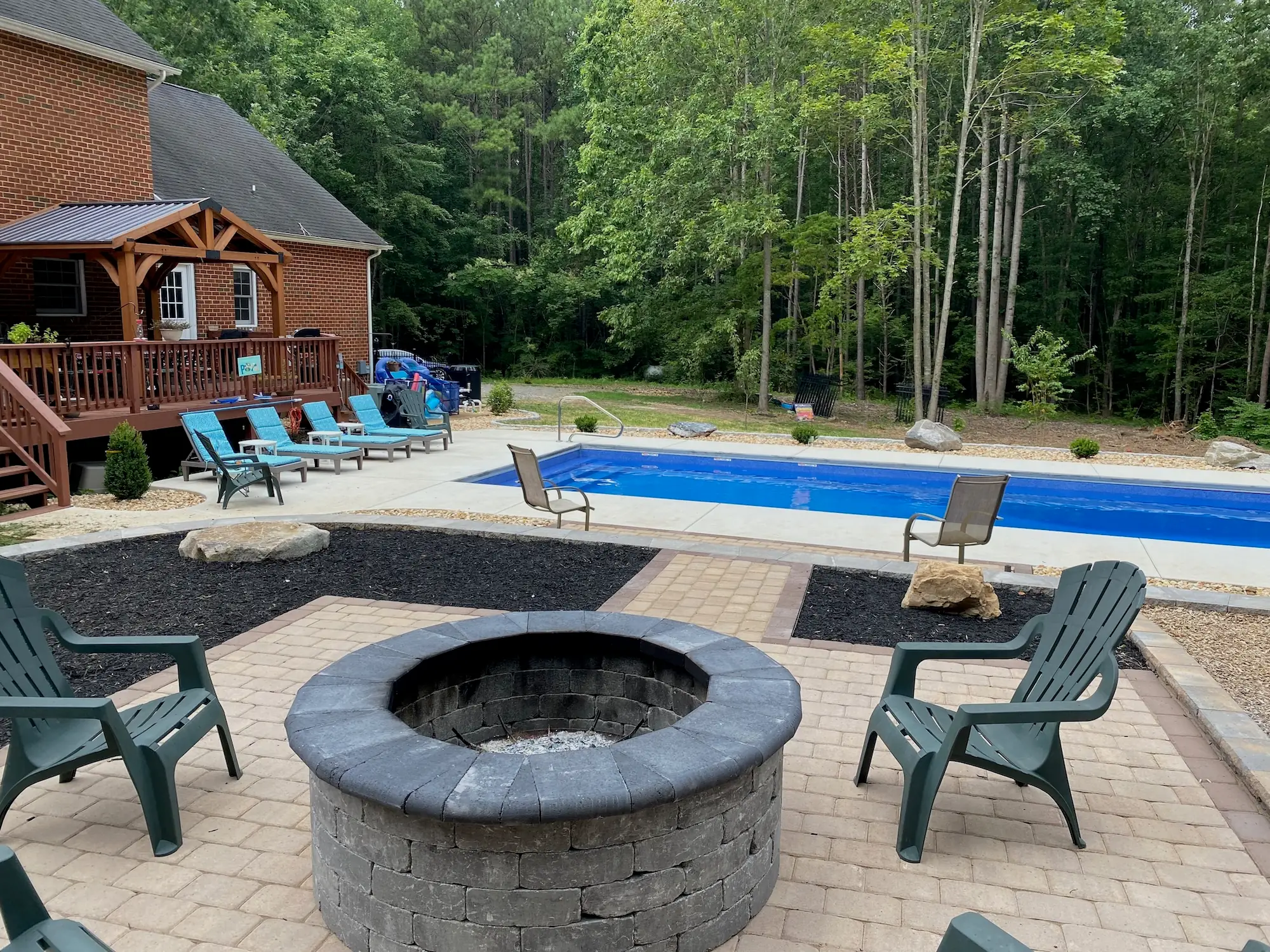 Pool Side project with stone fire pit, patio and landscaped pool surround